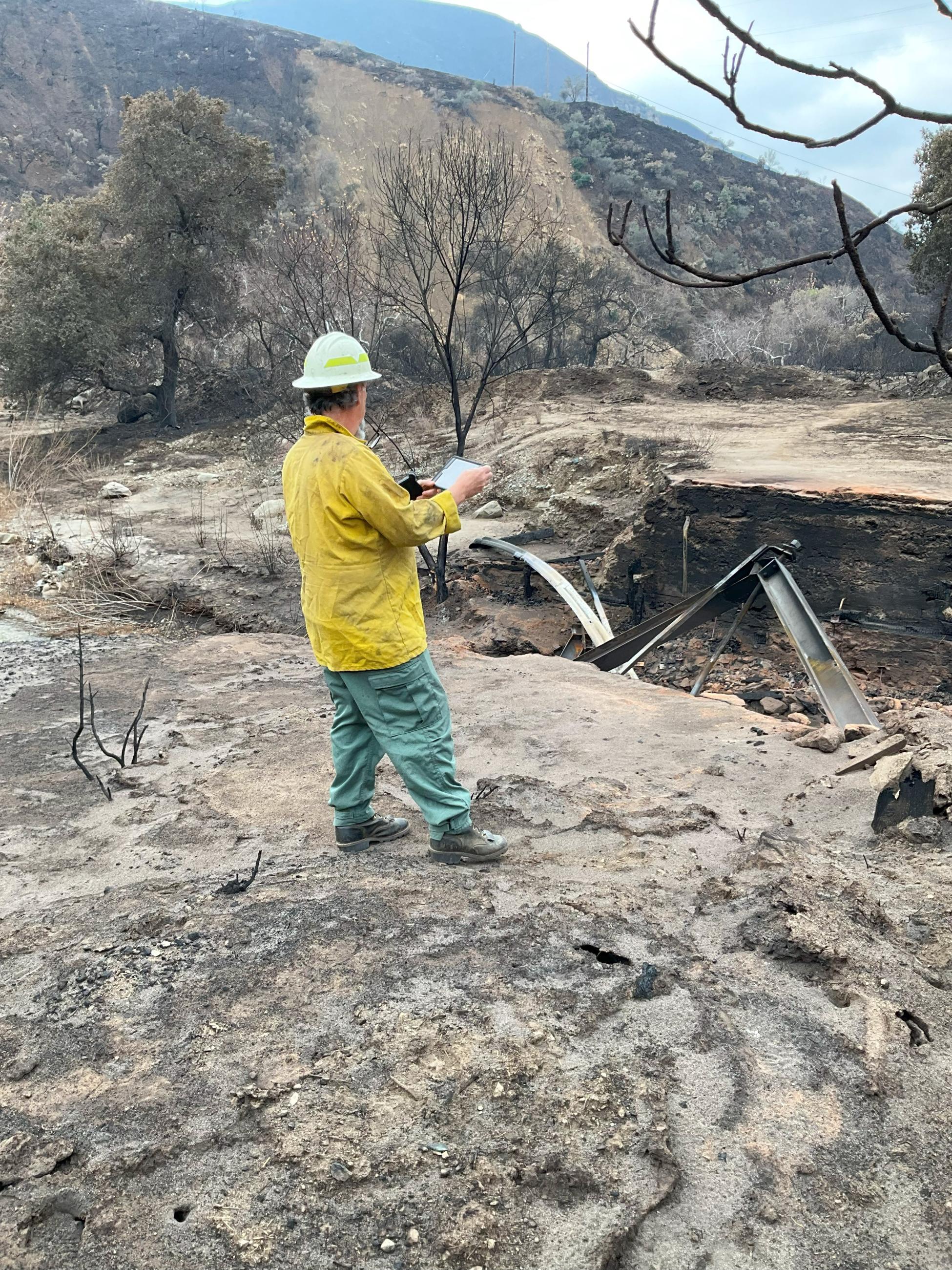 Photo Image Showing BAER Hydrologist Assesses Stream Channel Conditions in Hughes Burn Area