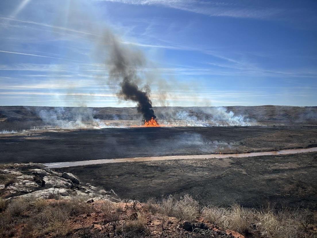 Rising black and gray smoke column coming from uptick in fire activity through heavy fuels.