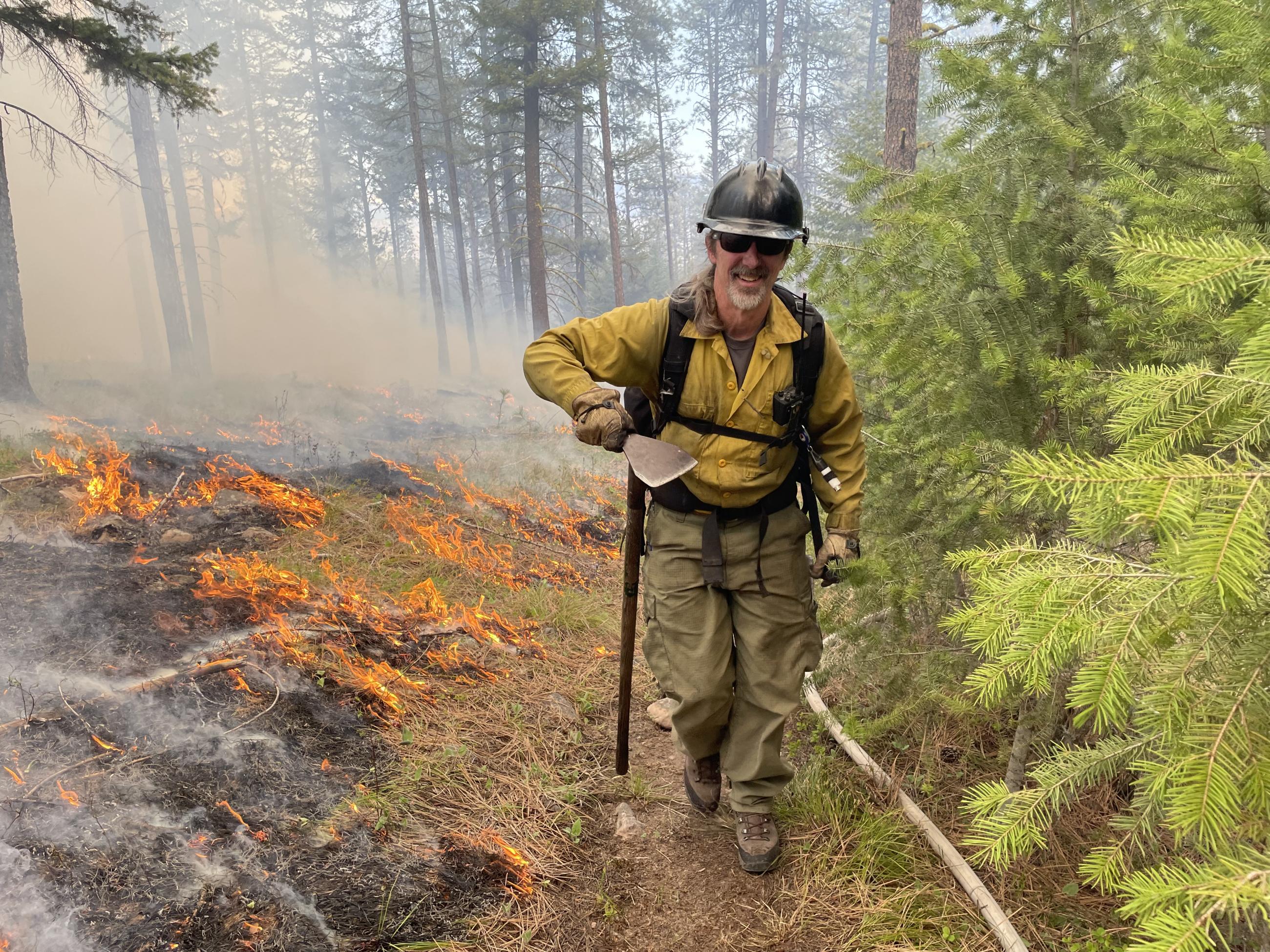 Firefighter near the edge of a prescribed fire 