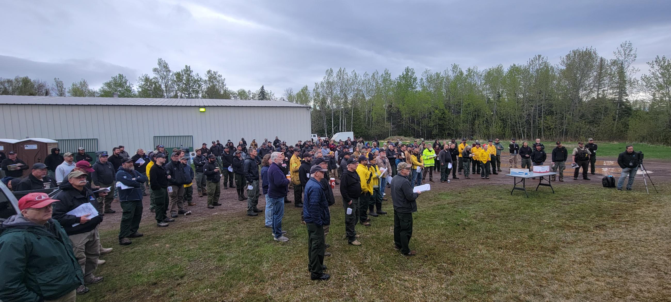 Firefighters stand in attendance for the Camp House & Jenkins Fire Morning Briefing on May 17, 2025