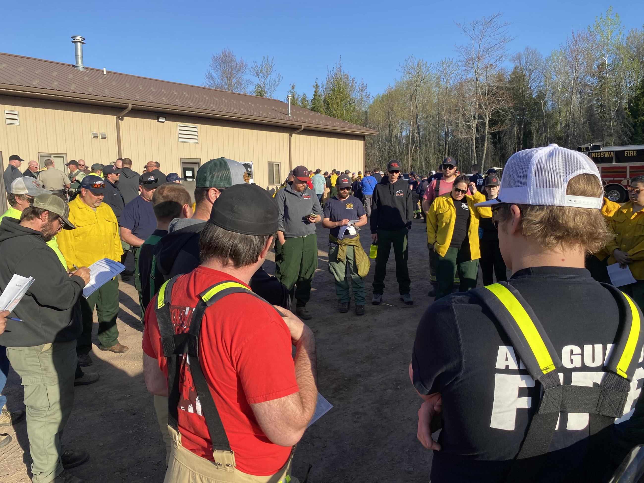 Fire crews gather outside to discuss fire operations.