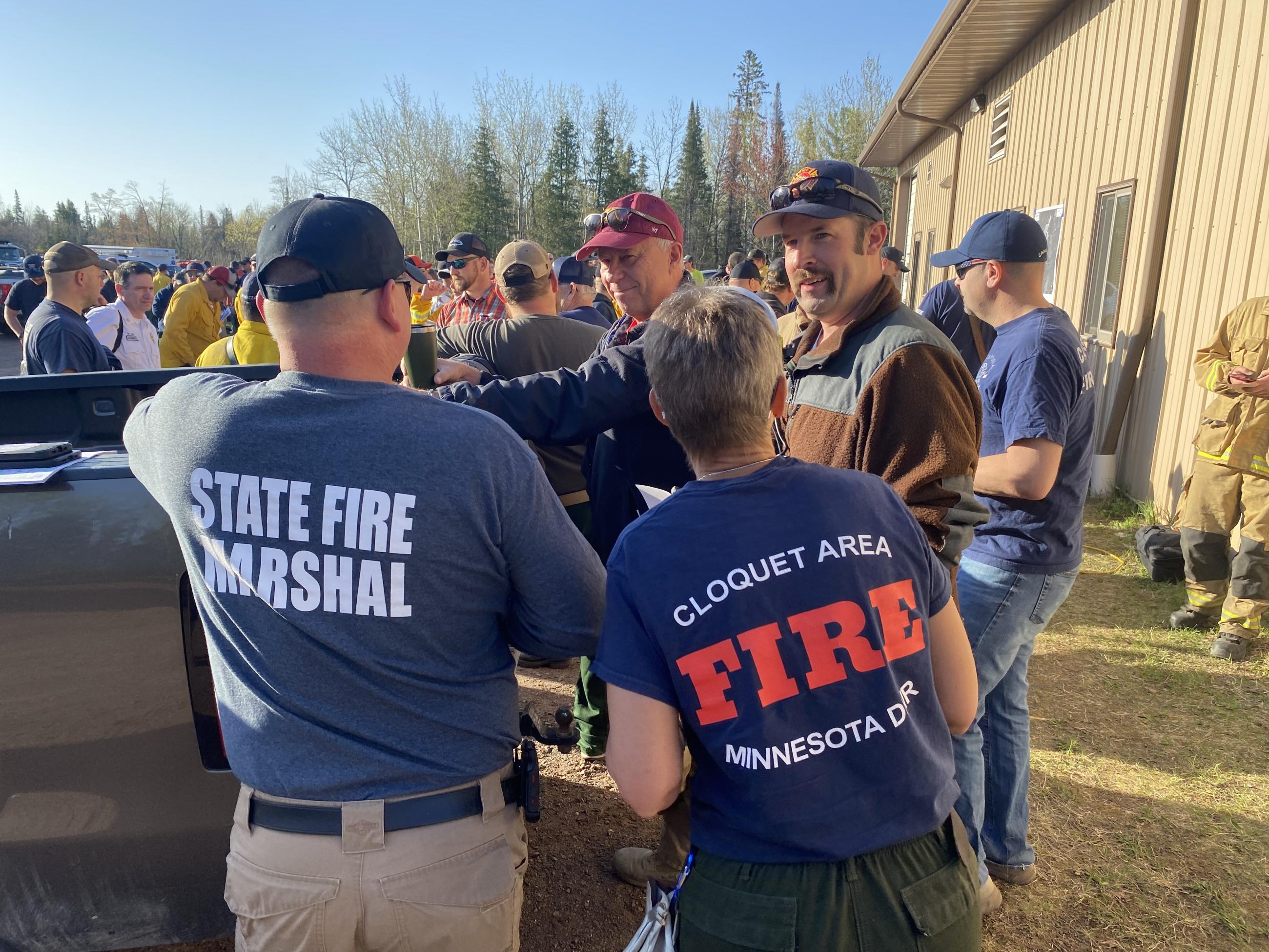 Fire crews gather outside to discuss fire operations.