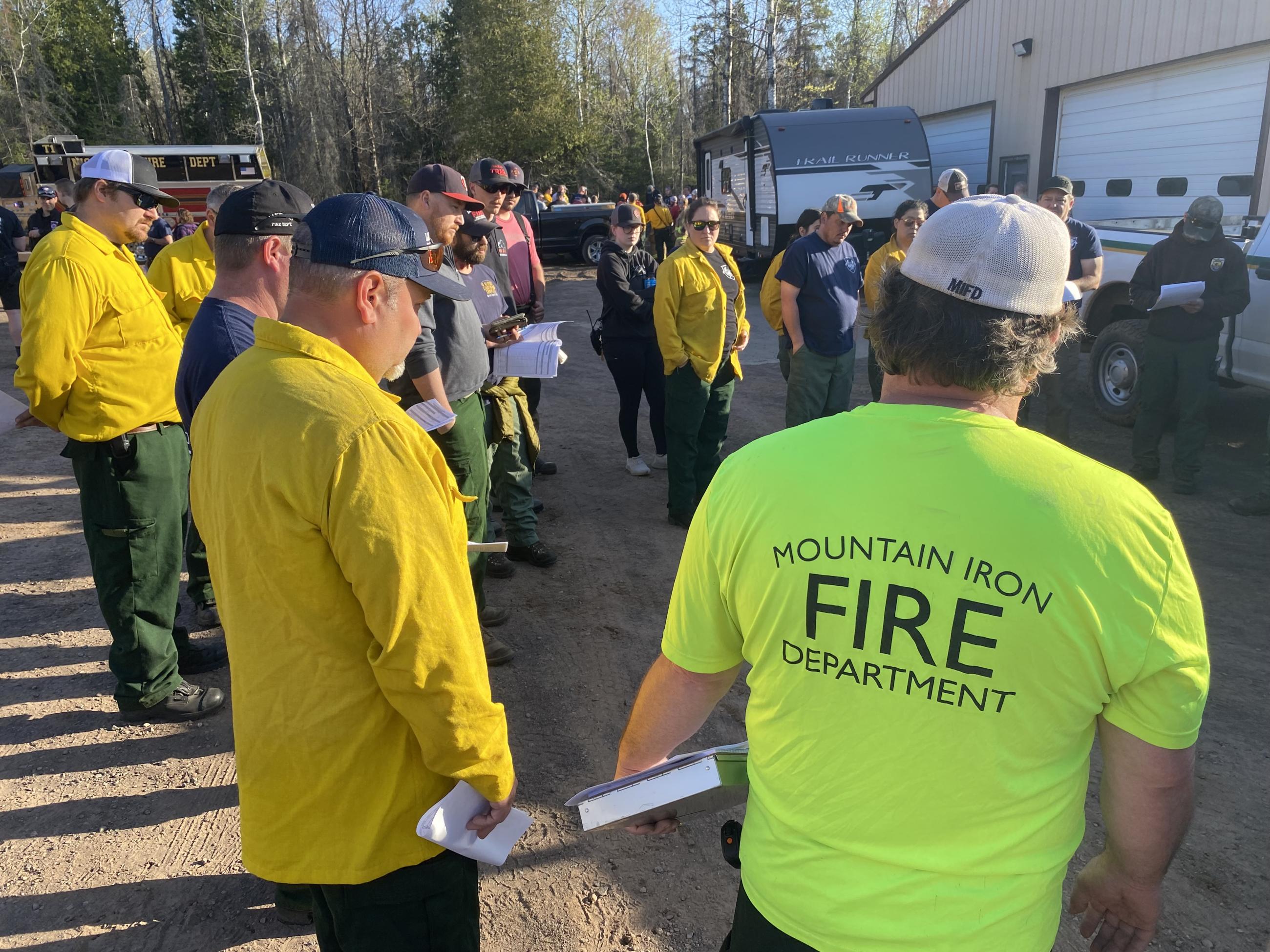Fire crews gather outside to discuss fire operations.