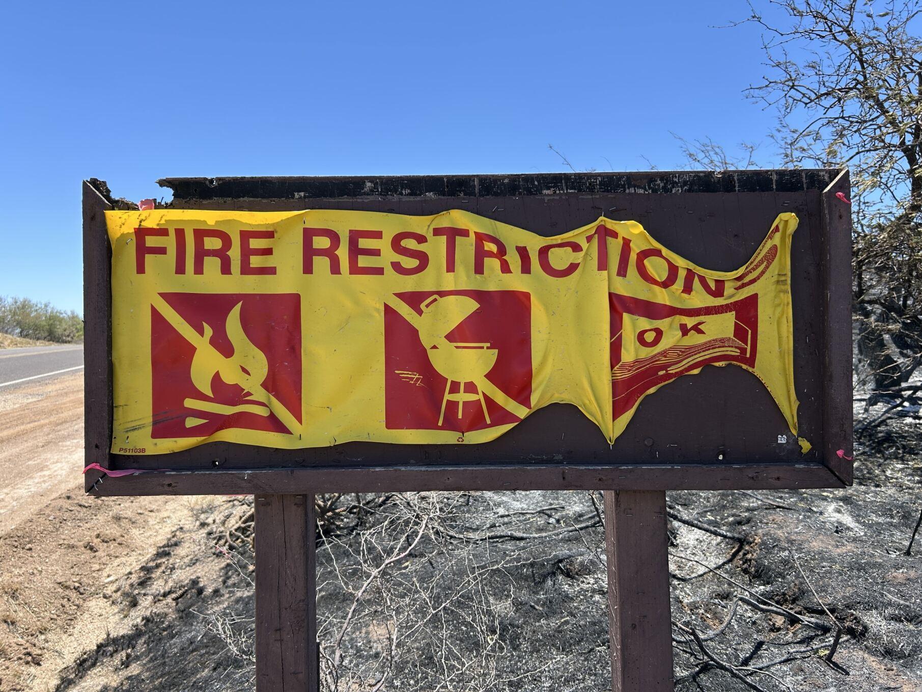 Picture of fire restriction sign that was burned and melting.